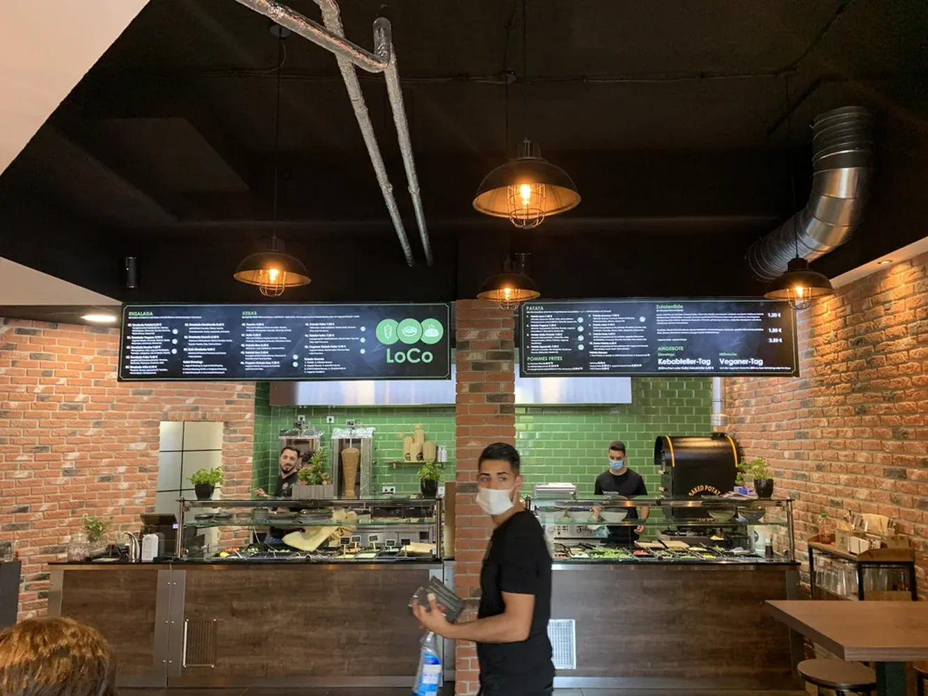 Illuminated menu boards above the bar counter