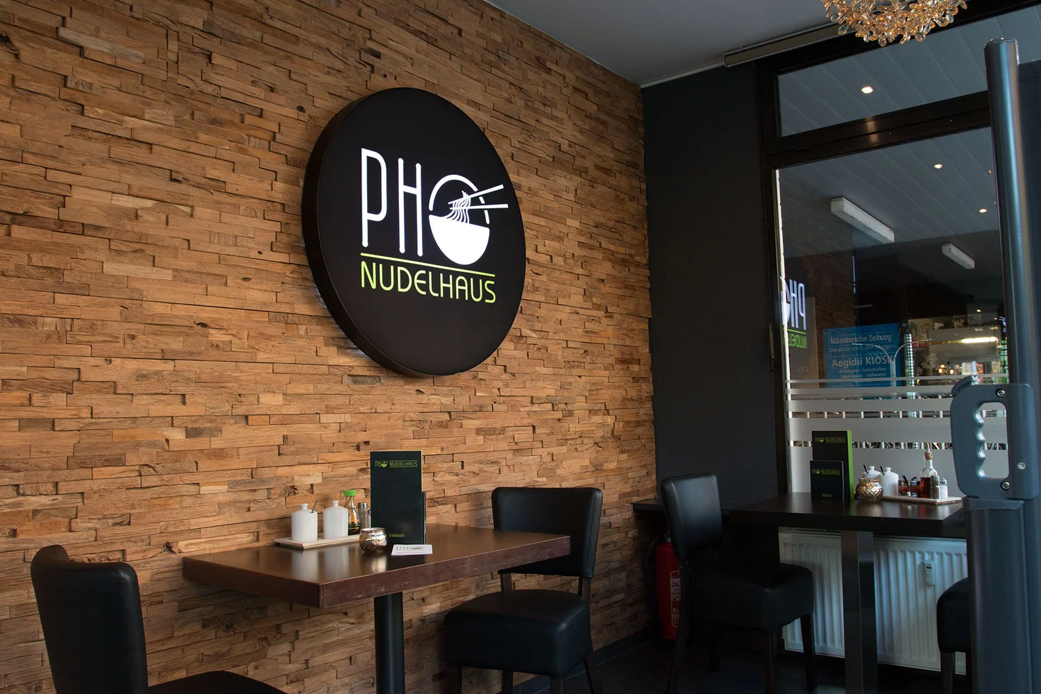 Illuminated logo on the wooden wall
