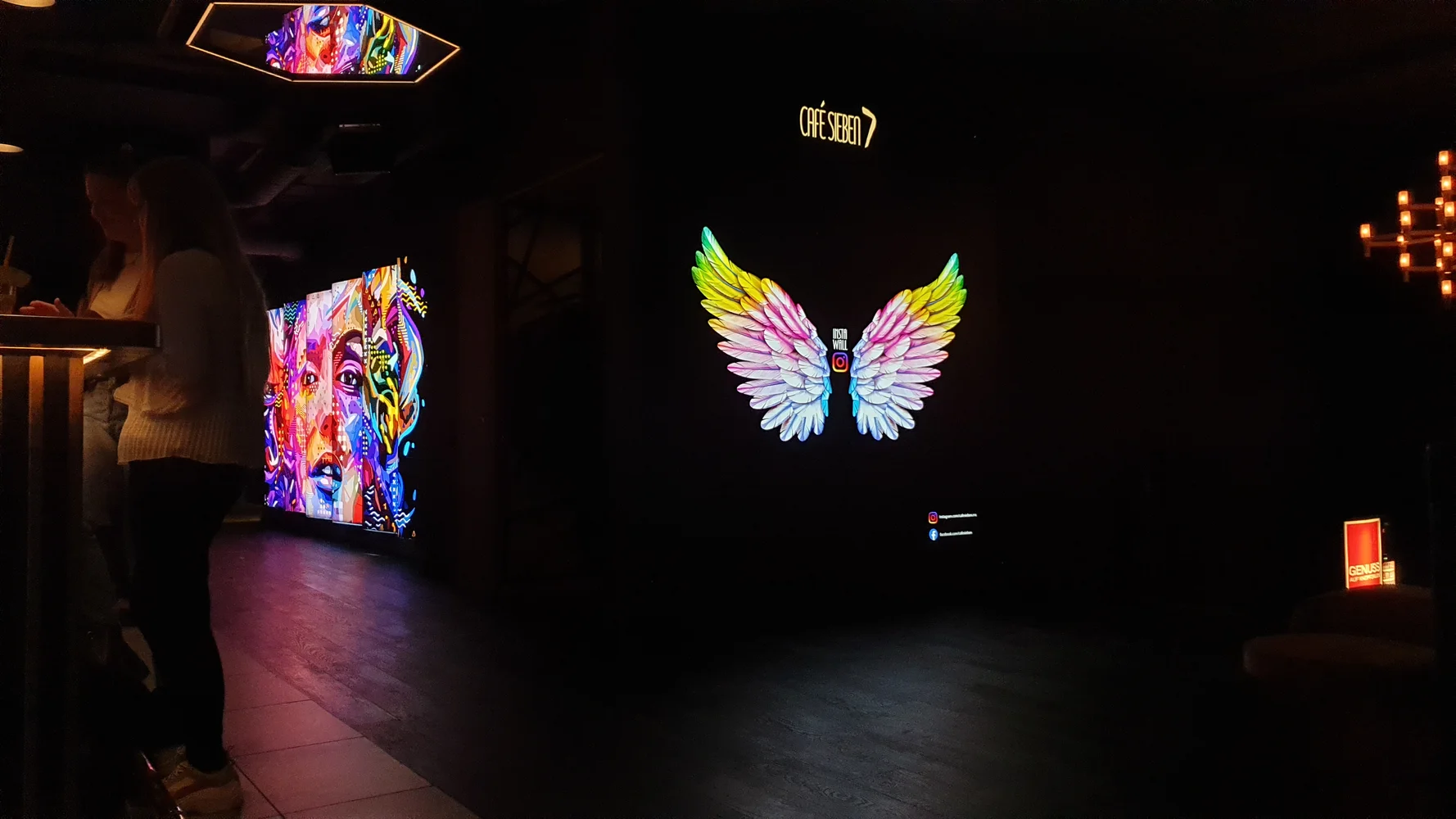 Illuminated pictures in a bar with dimmed lighting