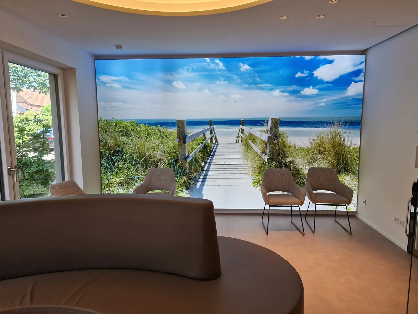 Light wall with a beach image in the waiting area of a medical practice